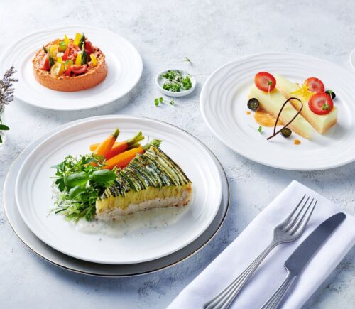 Photo shows the zucchini tart, which is one of the nearly 500 plant-based options now available on Emirates flights. The airline is doubling down on vegan airplane food in 2026