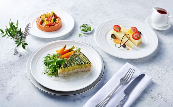 Photo shows the zucchini tart, which is one of the nearly 500 plant-based options now available on Emirates flights. The airline is doubling down on vegan airplane food in 2026