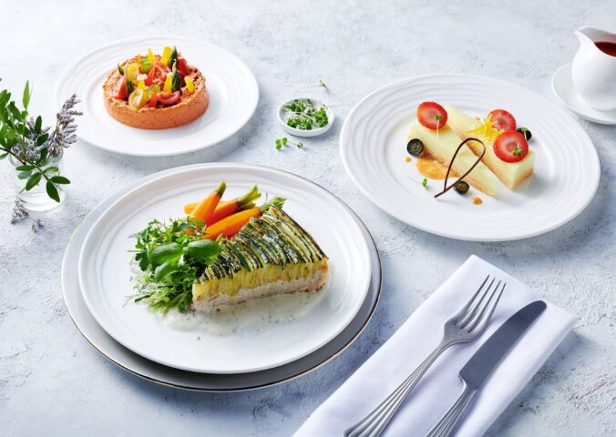 Photo shows the zucchini tart, which is one of the nearly 500 plant-based options now available on Emirates flights. The airline is doubling down on vegan airplane food in 2026