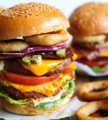 a meat-free mega burger stacked with dairy-free cheese, salad, and onion rings for recipes that aren't bowls or salads