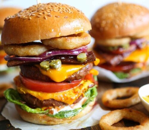 a meat-free mega burger stacked with dairy-free cheese, salad, and onion rings for recipes that aren't bowls or salads