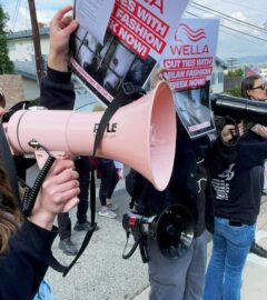Photo shows CAFT activists demonstrating, including one person holding a bullhorn and another holding a placard. Wella announced that it will no longer sponsor Milan Fashion Week following recent protests and public pressure over fur.