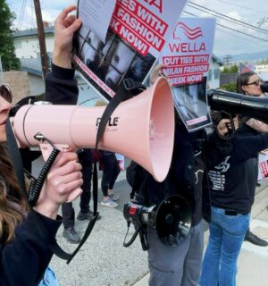 Photo shows CAFT activists demonstrating, including one person holding a bullhorn and another holding a placard. Wella announced that it will no longer sponsor Milan Fashion Week following recent protests and public pressure over fur.