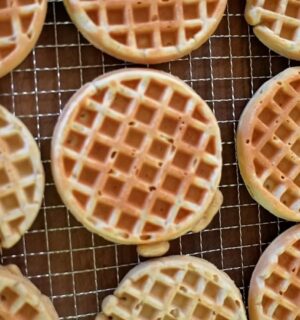 Freshly made oat waffles cooling on a wire rack as part of freezer friendly vegan meals prep