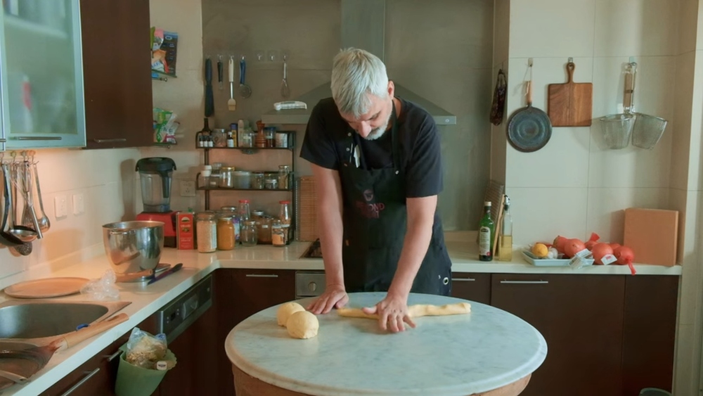 Roudaut shapes three strands of dough to form the braided vegan Easter brioche, ready for its final rise before baking