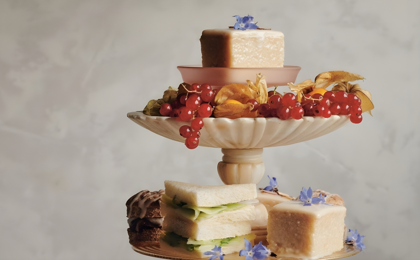 a picture of almond tea cakes made with marzipan, apricot jam, and topped with flowers for your next tea party