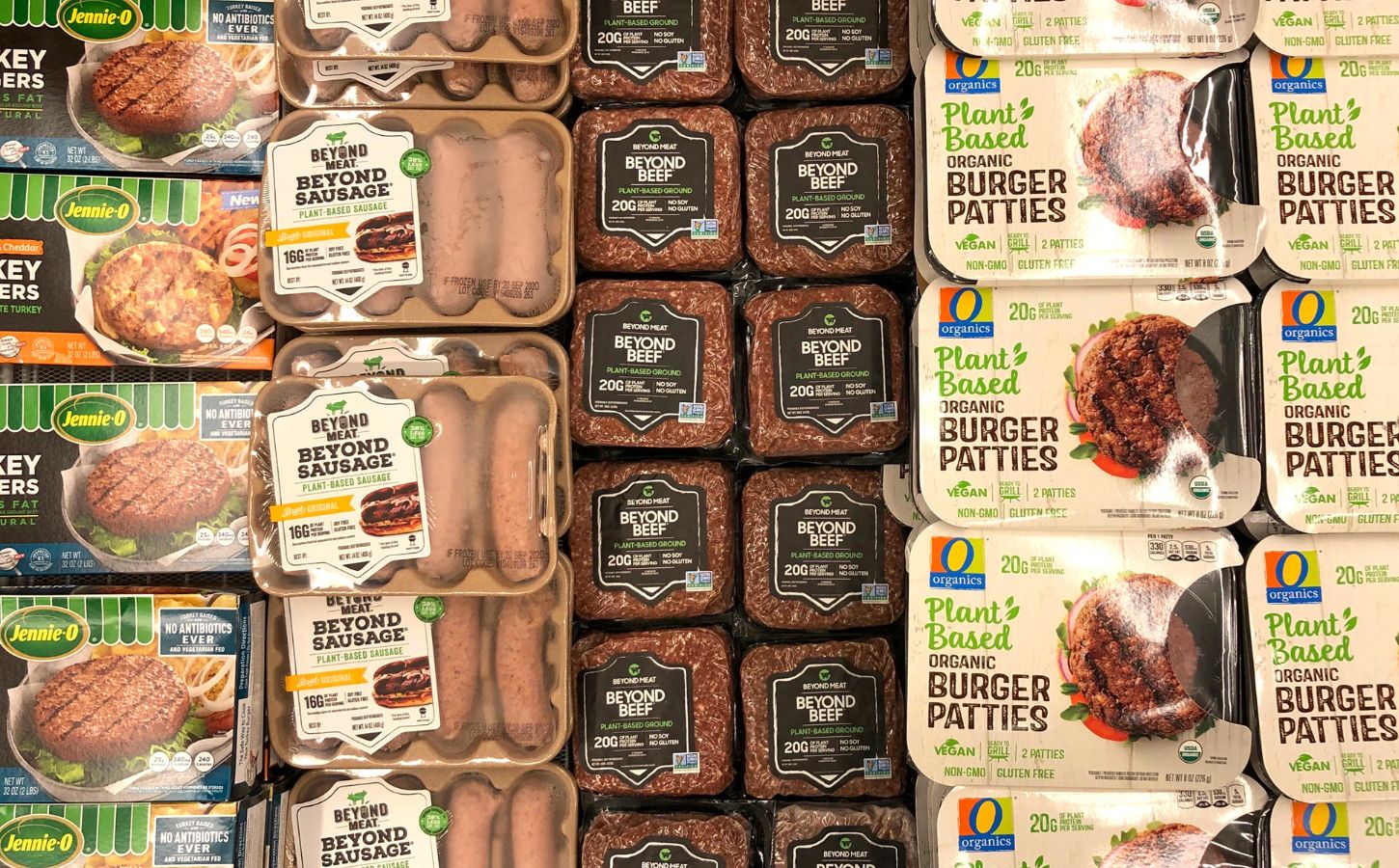 Photo shows a large refrigerator full of plant-based burgers, sausages, and other meat-alternatives, including several products made by Beyond Meat