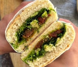 Herby Edamame And Sun-Dried Tomato Sandwich with fresh arugula