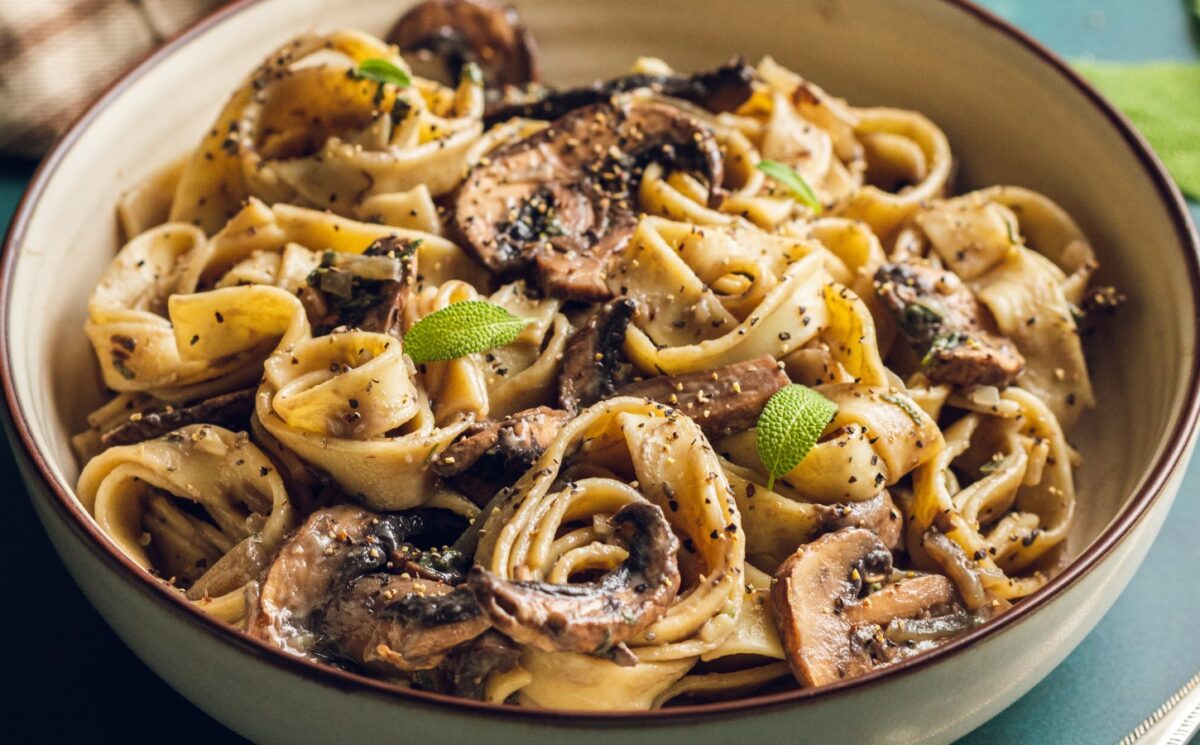 A plate of mushroom and sage pasta cooked to a dairy-free and vegan recipe for lazy vegan dinners