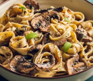 A plate of mushroom and sage pasta cooked to a dairy-free and vegan recipe for lazy vegan dinners