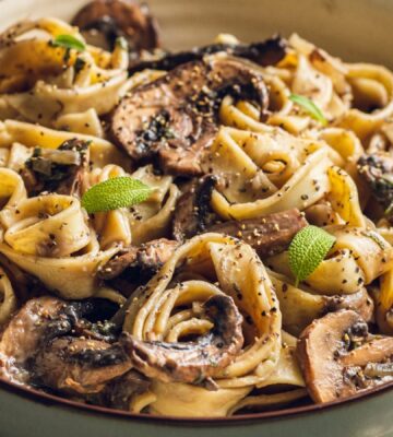 A plate of mushroom and sage pasta cooked to a dairy-free and vegan recipe for lazy vegan dinners