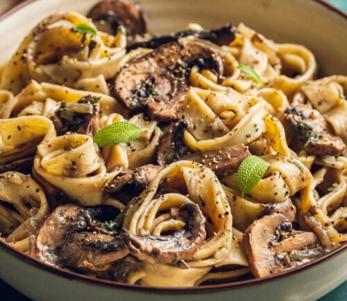 A plate of mushroom and sage pasta cooked to a dairy-free and vegan recipe for lazy vegan dinners