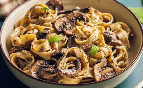 A plate of mushroom and sage pasta cooked to a dairy-free and vegan recipe for lazy vegan dinners
