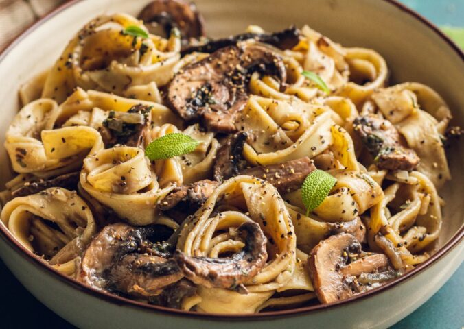 A plate of mushroom and sage pasta cooked to a dairy-free and vegan recipe for lazy vegan dinners