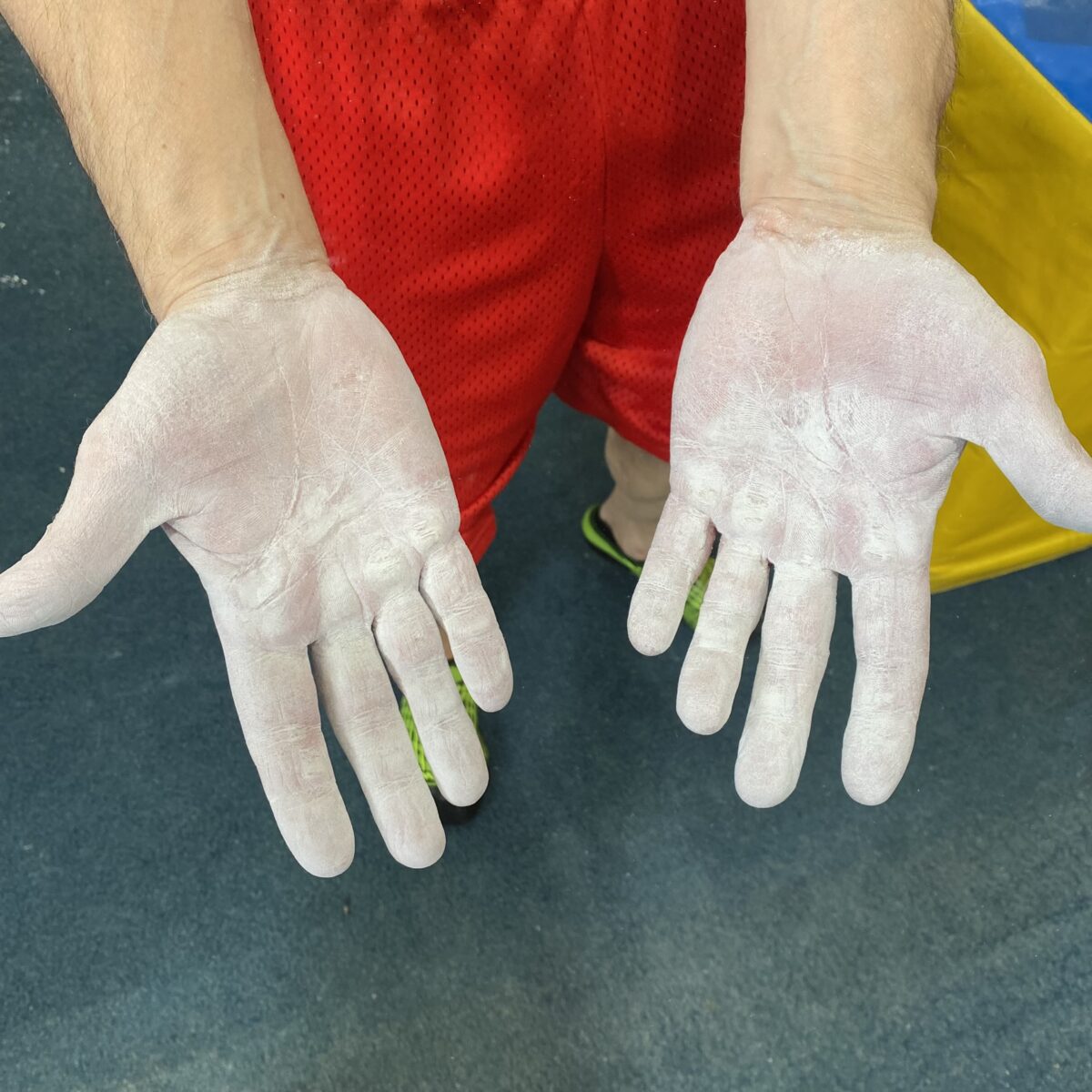 Photo shows the chalk-covered hands of vegan bodybuilder and former gymnast Joe DeMarco, who has set a new Guinness World Record at the age of 61 by performing 602 “toes to bar” movements in one hour