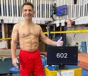 Photo shows vegan bodybuilder and former gymnast Joe DeMarco, who has set a new Guinness World Record at the age of 61 by performing 602 “toes to bar” movements in one hour