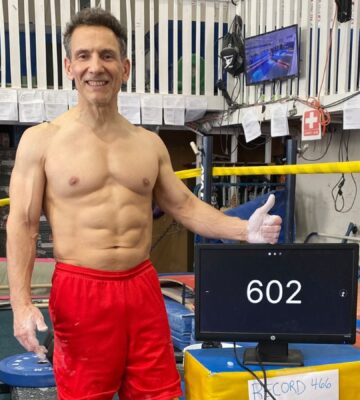 Photo shows vegan bodybuilder and former gymnast Joe DeMarco, who has set a new Guinness World Record at the age of 61 by performing 602 “toes to bar” movements in one hour