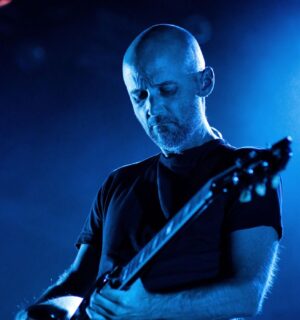 Photo shows Moby performing onstage. Vegan Camp Out has announced that Moby will speak at this year’s festival.