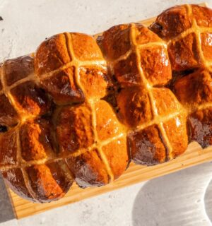 vegan hot cross bun loaf with raisins and an apricot jam glaze
