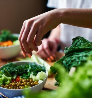 Photo shows a woman's hands as she prepares a salad with fresh fruits and vegetables and leafy greens. Vegetarians have “substantially lower” risk of five common types of cancer, according to a landmark new study.
