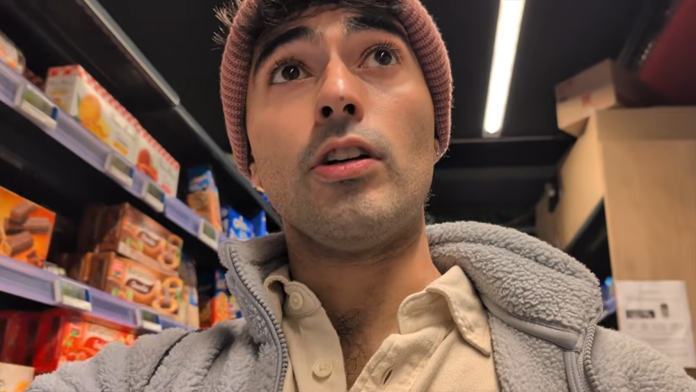 Marton walking down a grocery store aisle, showing how to shop for ingredients for quick vegan breakfasts