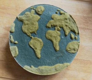 Shot of Couse's Earth Day vegan cheesecake with a green land-inspired layer and a blue one representing the ocean