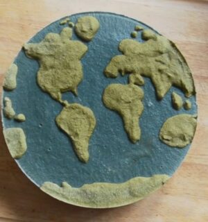 Shot of Couse's Earth Day vegan cheesecake with a green land-inspired layer and a blue one representing the ocean
