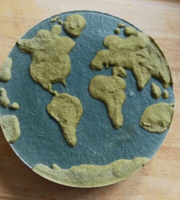 Shot of Couse's Earth Day vegan cheesecake with a green land-inspired layer and a blue one representing the ocean