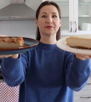 Shot of Maddie holding up two slices of vegan cheesecake that she will analyze, to test the flavor behind the viral chickpea cheesecake recipes