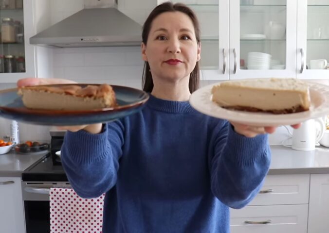 Shot of Maddie holding up two slices of vegan cheesecake that she will analyze, to test the flavor behind the viral chickpea cheesecake recipes