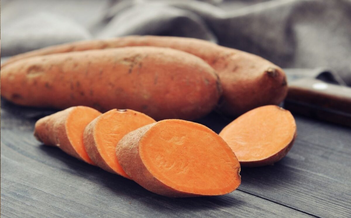 Shot of a sweet potato and one cut up in rounds to illustrate article on how to boost carotenoid absorption