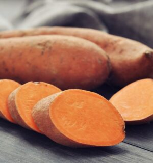 Shot of a sweet potato and one cut up in rounds to illustrate article on how to boost carotenoid absorption