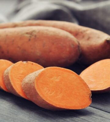 Shot of a sweet potato and one cut up in rounds to illustrate article on how to boost carotenoid absorption