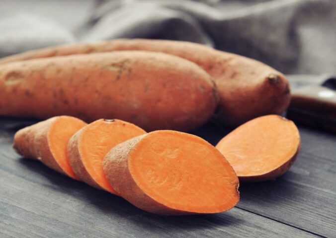 Shot of a sweet potato and one cut up in rounds to illustrate article on how to boost carotenoid absorption
