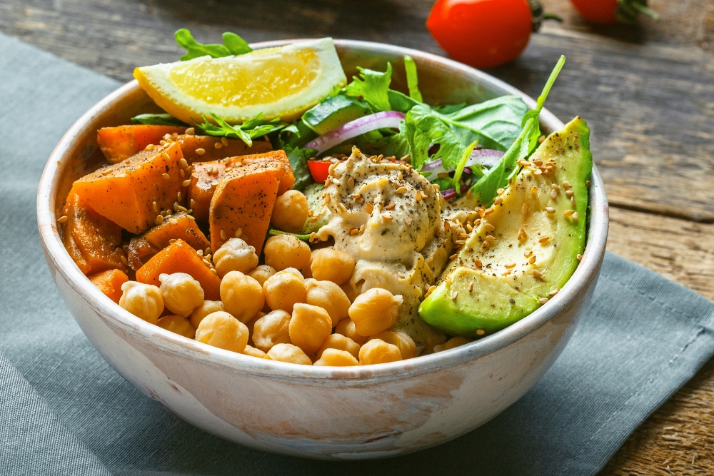 Bowl of chickpeas, salad, sweet potato and avocado to illustrate article on how to boost carotenoid absorption