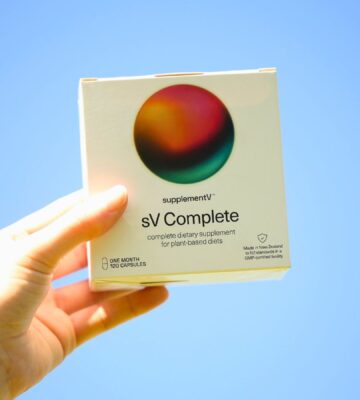 Photo shows someone's hand holding up a packet of supplementV's sV Complete, a vegan all-in-one supplement that the company says is more than just a multivitamin