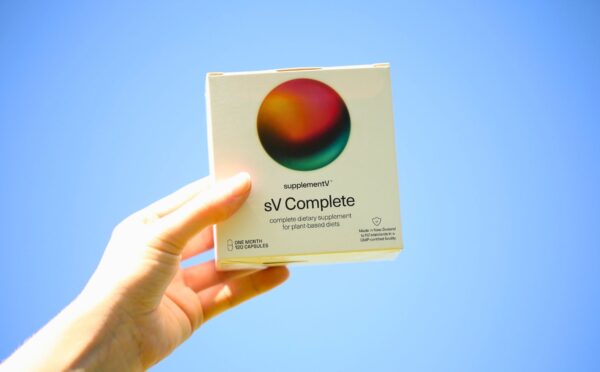 Photo shows someone's hand holding up a packet of supplementV's sV Complete, a vegan all-in-one supplement that the company says is more than just a multivitamin