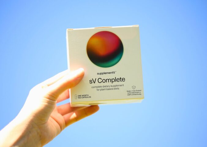 Photo shows someone's hand holding up a packet of supplementV's sV Complete, a vegan all-in-one supplement that the company says is more than just a multivitamin