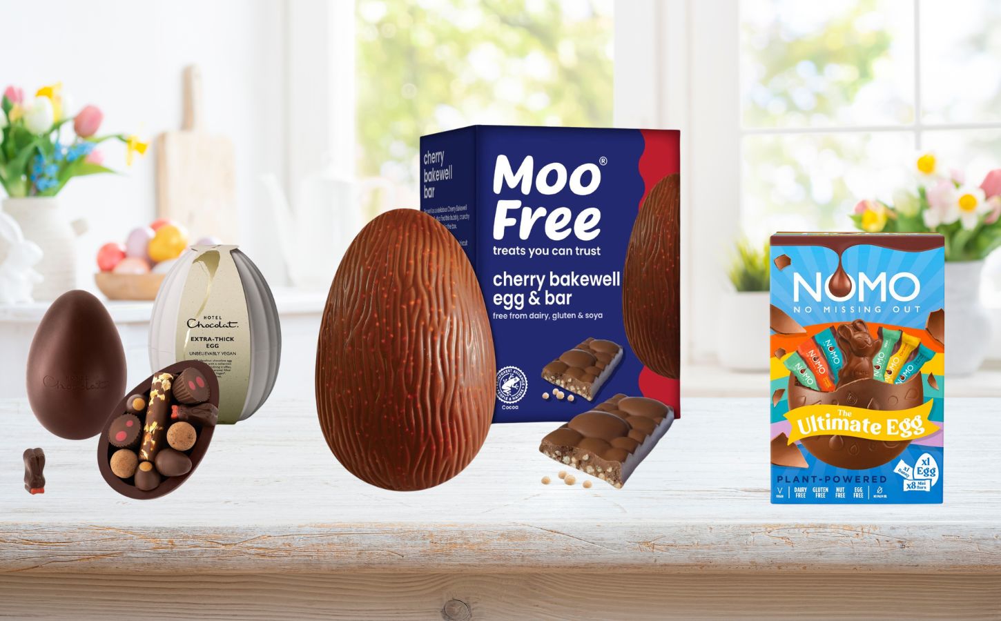Photo shows three of the 10 best vegan easter eggs of 2026 in stores right now, including the Moo Free Cherry Bakewell egg, the Nomo "Ultimate" egg, and the Hotel Chocolat "Extra Thick" vegan Easter egg