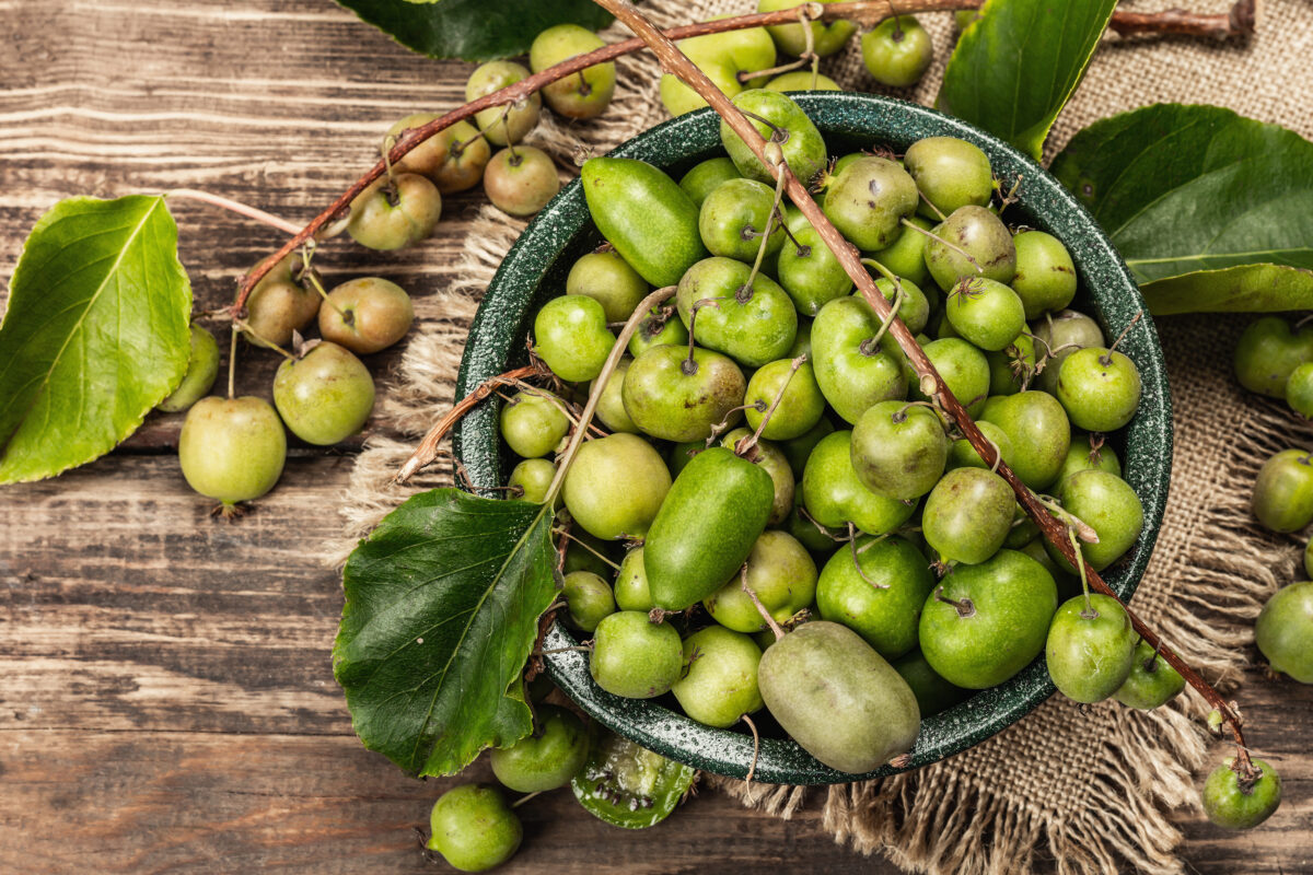 Photo shows a bowl full of kiwiberries on a wooden table. The kiwiberry, a tiny and sweet-tasting fruit, could help to slow or even stop lung cancer growth, according to the latest in a series of studies.