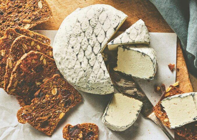A wheel of snow white rind vegan cheese like brie or camembert for vegan charcuterie