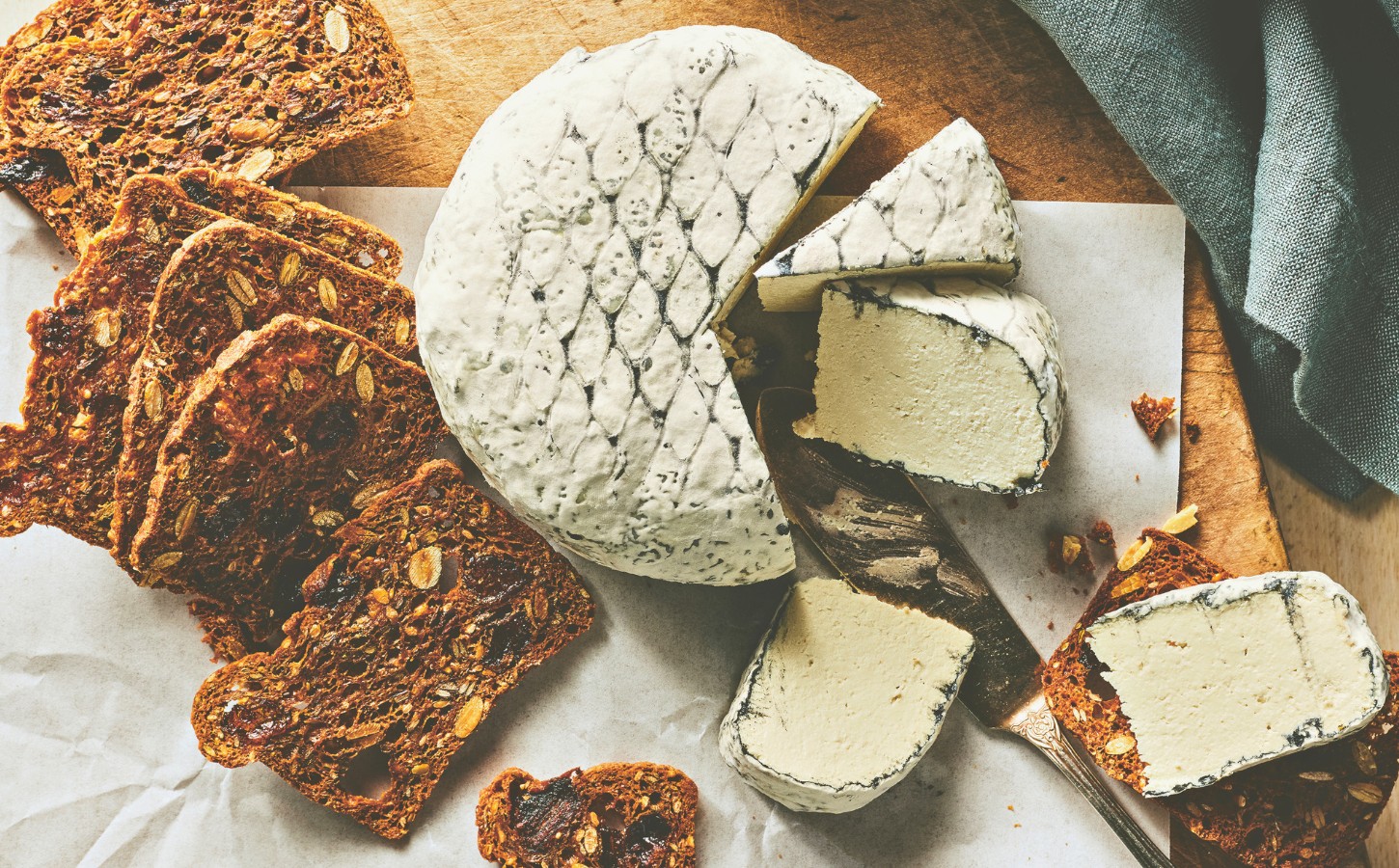 A wheel of snow white rind vegan cheese like brie or camembert for vegan charcuterie