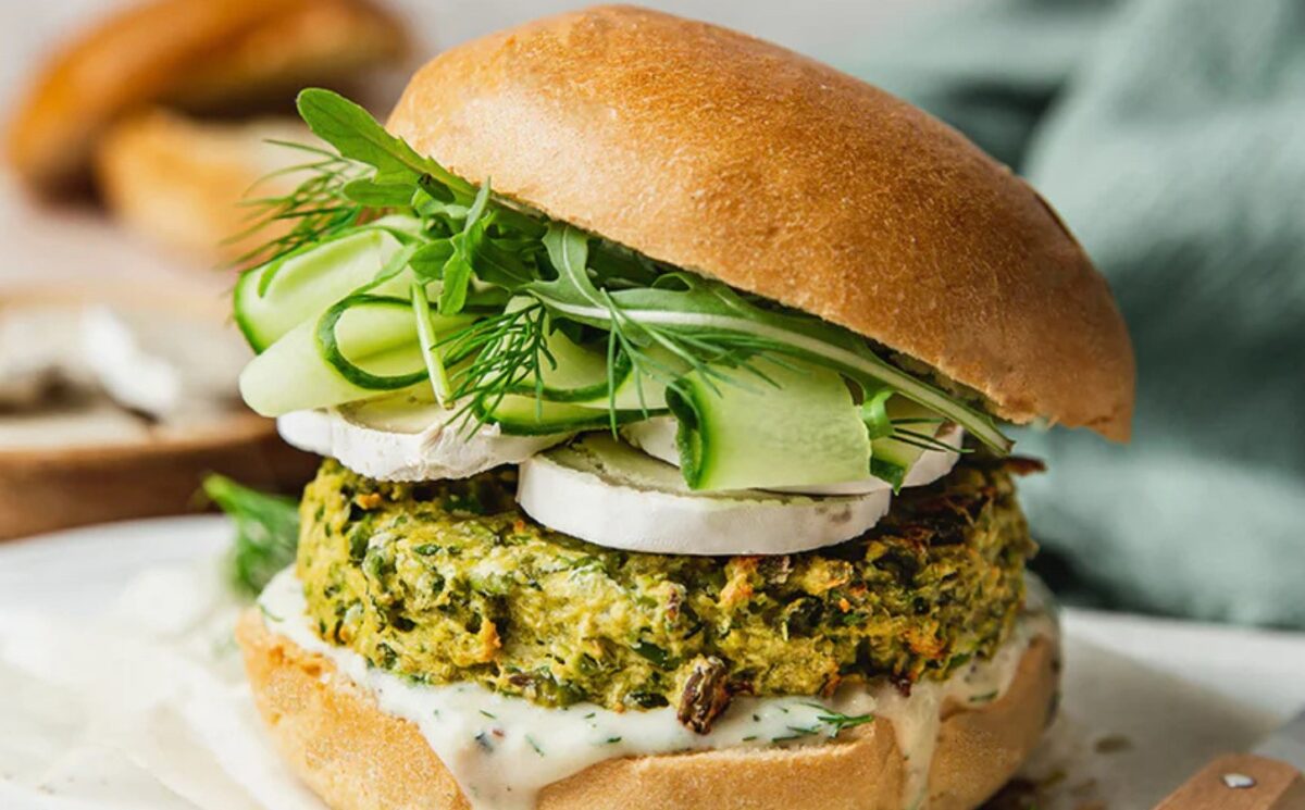 Spring Burger with courgette and pea cakes, a soy yogurt sauce, and goats cheese alternative