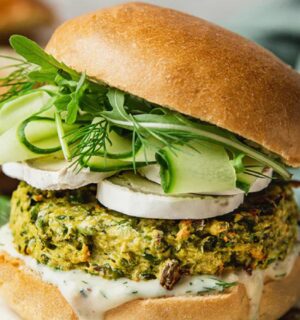 Spring Burger with courgette and pea cakes, a soy yogurt sauce, and goats cheese alternative