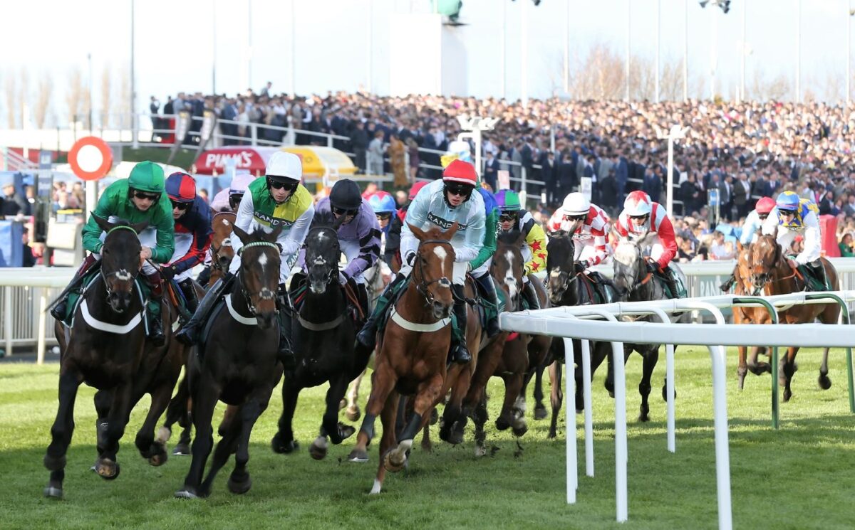 Photo shows racehorses and riders during the 2022 Grand National Festival at Aintree