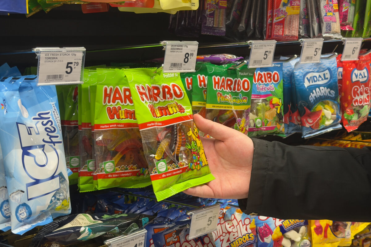 Photo shows someone reaching for a pack of Haribo on the supermarket shelves