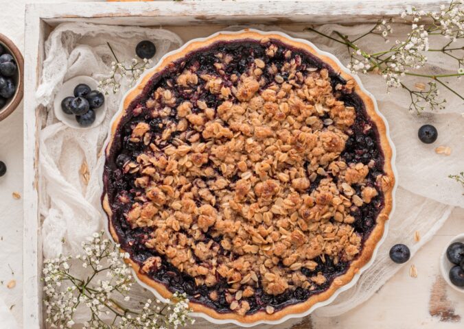 blueberry crumble pie with vegan ingredients and oat crumble
