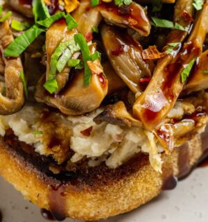 Butter Beans And Mushrooms On Toast with lemon, olive oil, artichokes, and balsamic glaze