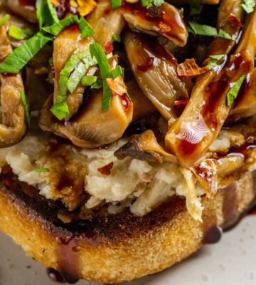 Butter Beans And Mushrooms On Toast with lemon, olive oil, artichokes, and balsamic glaze