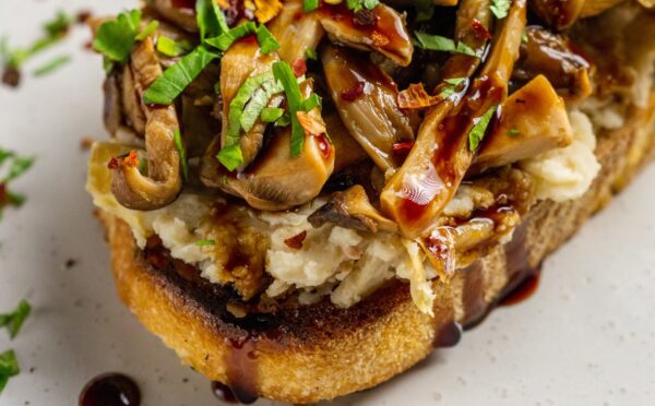 Butter Beans And Mushrooms On Toast with lemon, olive oil, artichokes, and balsamic glaze